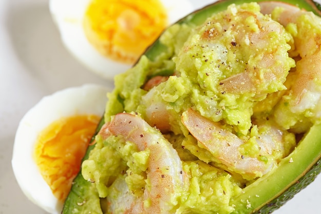 Stuffed avocado with garlic, eggs, and shrimps