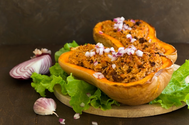 Stuffed baked pumpkin. close-up on a wooden table.