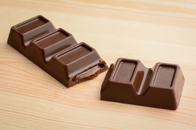 Stuffed bar of dark chocolate lays on table