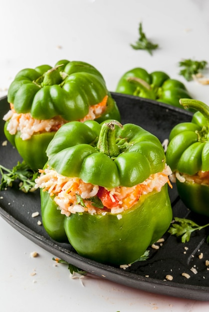 Stuffed bell pepper with minced meat, carrots, tomatoes, herbs and cheese