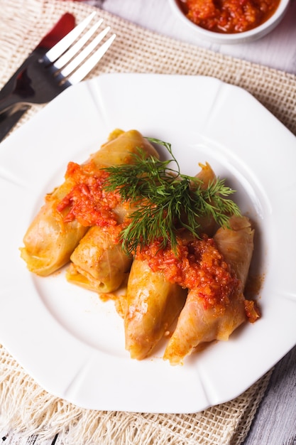 Stuffed cabbage with tomato dip on the plate