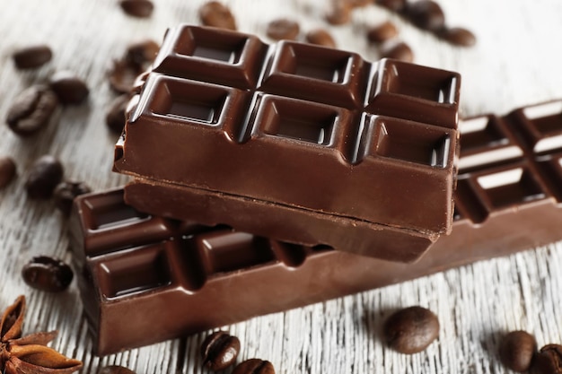 Stuffed chocolate with coffee beans on wooden table closeup