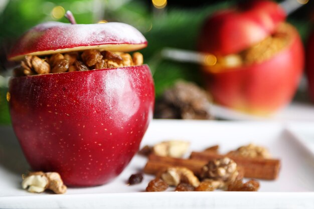 Stuffed Christmas apples with nuts and raisins on table close up