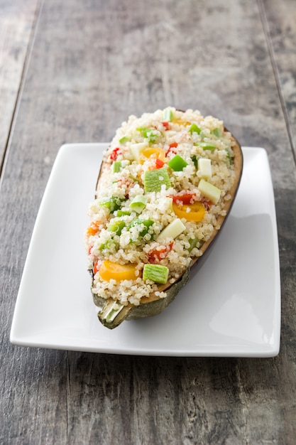 Stuffed eggplant with quinoa and vegetables on wooden table