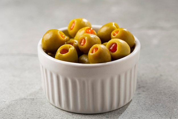 Stuffed green olives in a bowl.