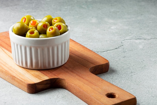 Stuffed green olives in a bowl.