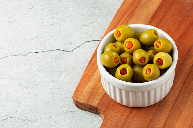 Stuffed green olives in a bowl.