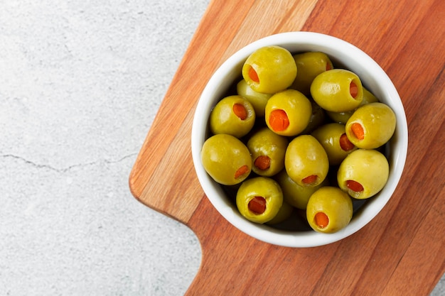 Stuffed green olives in a bowl.