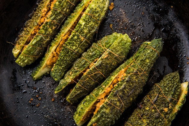 Stuffed Karela or Bitter Melon or Gourd. Traditional indian Vegetable recipe served in a plate or in a frying pan. Selective focus