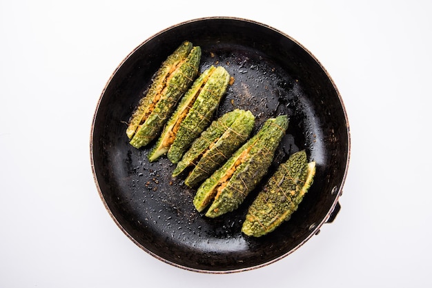 Stuffed Karela or Bitter Melon or Gourd. Traditional indian Vegetable recipe served in a plate or in a frying pan. Selective focus
