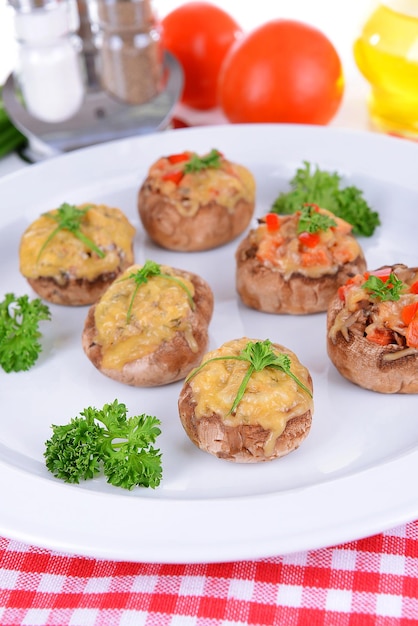 Stuffed mushrooms on plate on table closeup