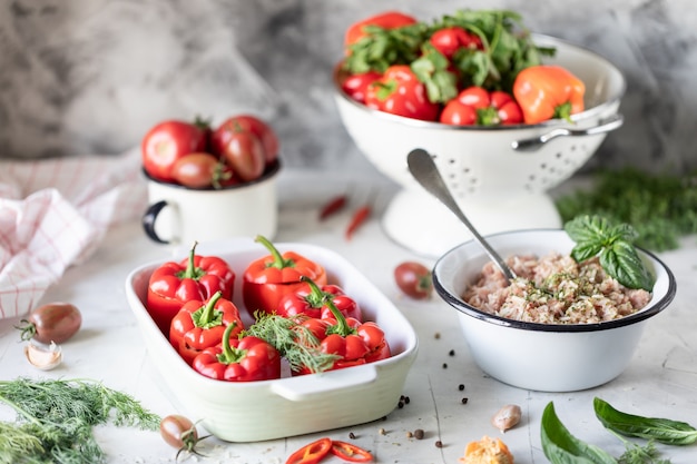 Stuffed red peppers with tomatoes and herbs cooked in the oven.