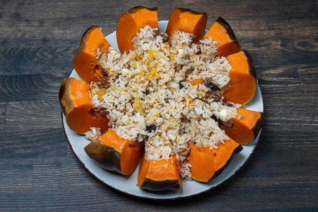 Stuffed roasted pumpkin whole baked filled with a mixture of rice raisins and spices