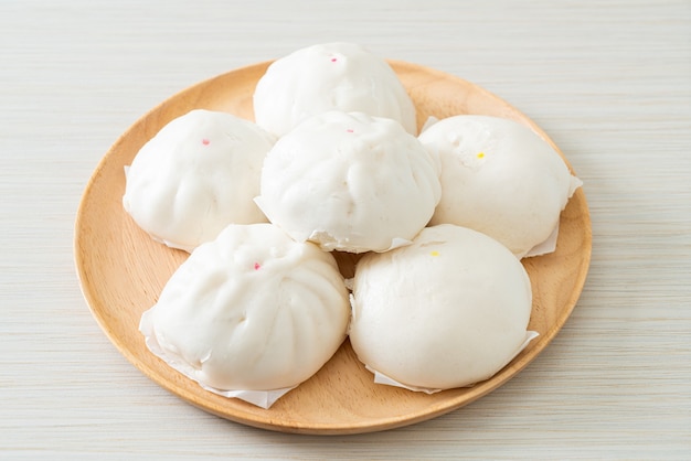 stuffed steamed bun on wood plate - Chinese food style