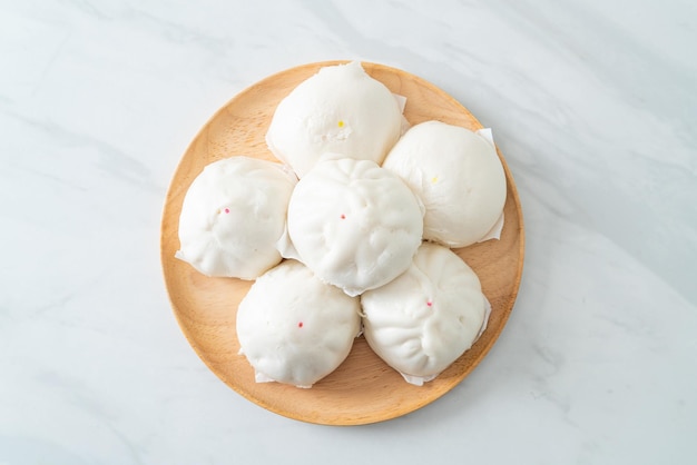 stuffed steamed bun on wood plate - Chinese food style