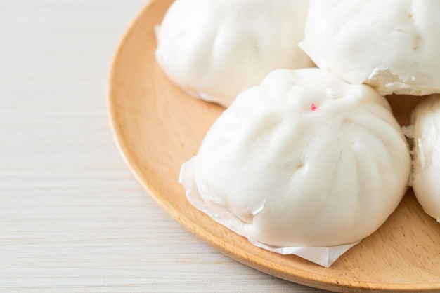 Stuffed steamed bun on wood plate