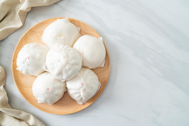 Stuffed steamed bun on wood plate