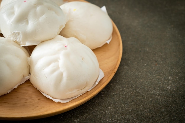 Stuffed steamed bun on wood plate