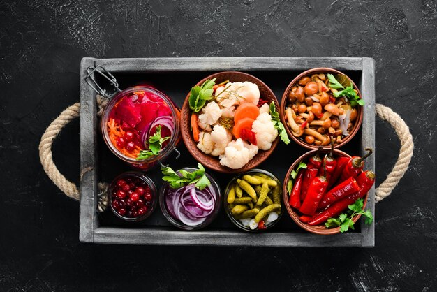 Stuffed vegetables and mushrooms on the kitchen table Cabbage mushrooms cucumbers cauliflower Top view Free space for your text