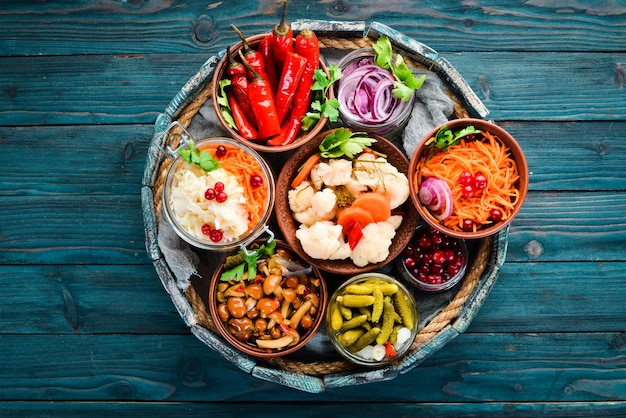 Stuffed vegetables and mushrooms on the kitchen table Cabbage mushrooms cucumbers cauliflower Top view Free space for your text