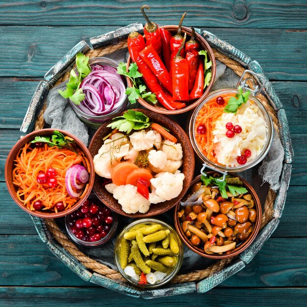 Stuffed vegetables and mushrooms on the kitchen table Cabbage mushrooms cucumbers cauliflower Top view Free space for your text