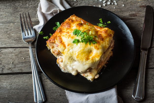 Stuk smakelijke hete lasagna&#39;s met rode wijn. Italiaanse lasagne. Italiaans eten. Bolognese. Becham