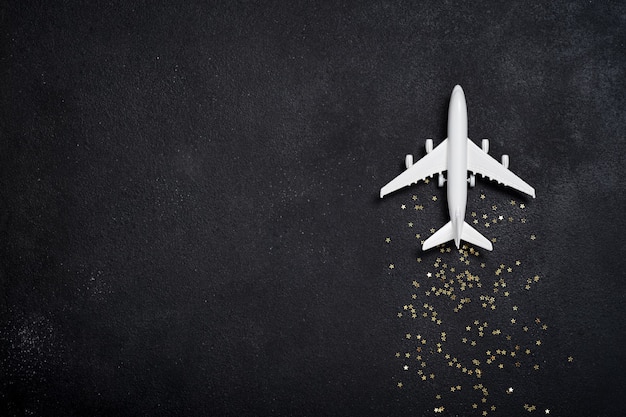 Stuk speelgoed wit vliegtuig met gouden sterren. Kerstconcept van reizen en bezorgen per vliegtuig, Nieuwjaar
