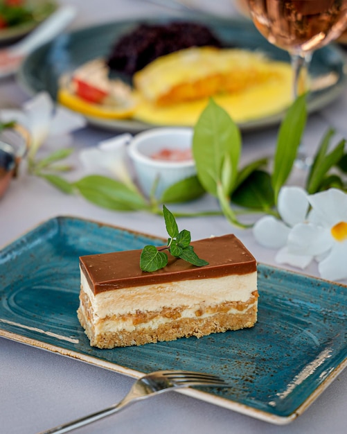 Stuk van smakelijke cake op de blauwe plaat