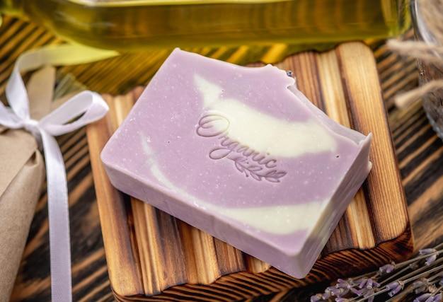 Stukjes traditionele Franse zeep op een houten zeepbak en een boeket lavendel Natuurlijke handgemaakte Marseille zeep met lavendel geur