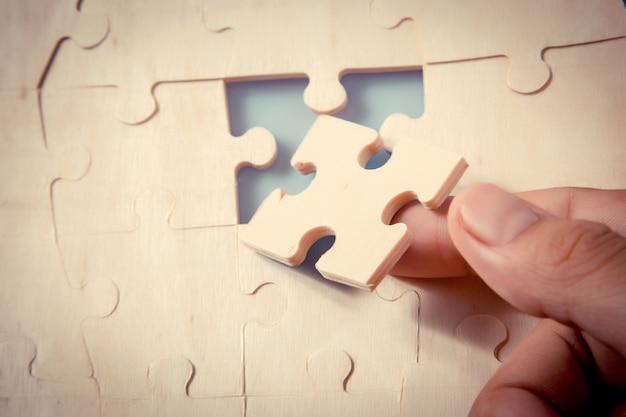 Stukken van puzzel in de handen van de vrouw