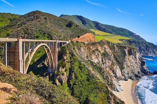 Stunning arched bixby bridge on west coast with beaches mountains and ocean