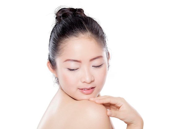 Stunning asian woman with glowing skin isolated over white background