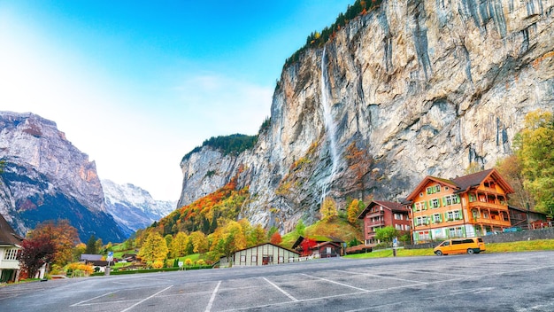 Stunning autumn view of Lauterbrunnen village with awesome waterfall Staubbach and Swiss Alps in the background