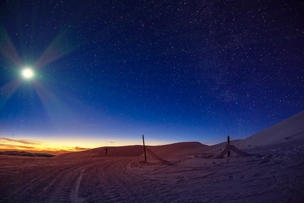 Stunning beautiful views of the slopes in the ski resort after sunset in the late evening. The concept of vacation in the northern country on holidays and New Year holidays