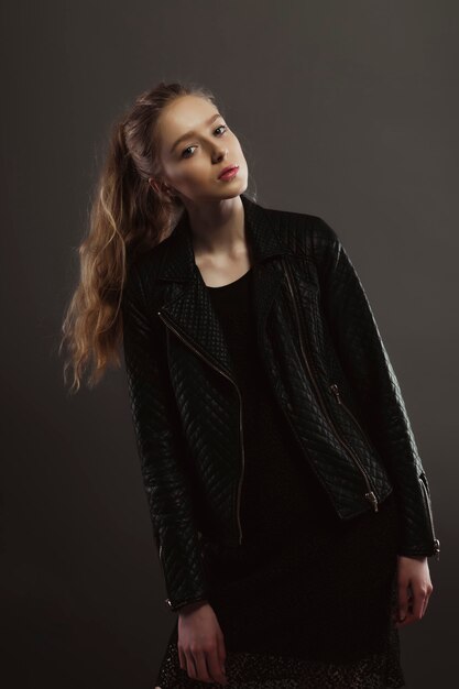 Stunning blonde model posing for model tests in leather jacket