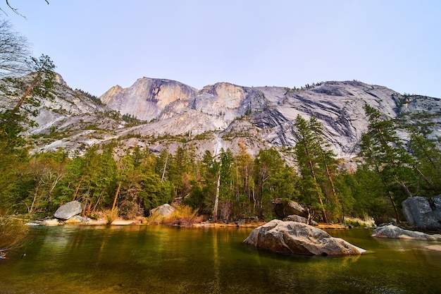 Stunning cliffs of Half Dome by lake at Yosemite National Park