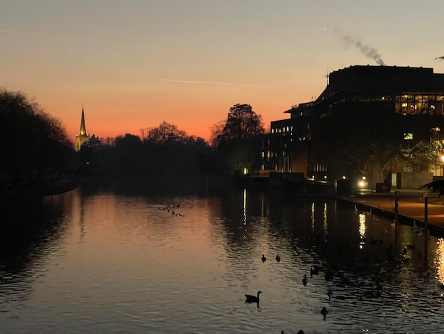 Stunning colorful sunset above the town on the river