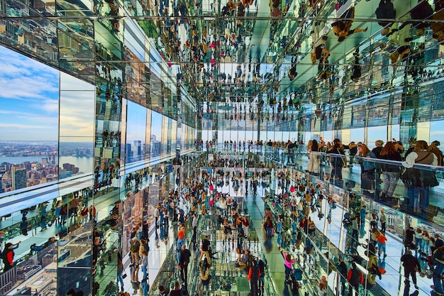 Stunning endless mirror reflection room inside Summit One skyscraper full of tourists overlooking Ne