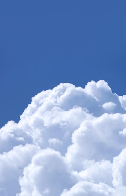 Stunning fluffy white cumulus clouds on vibrant blue sunny sky