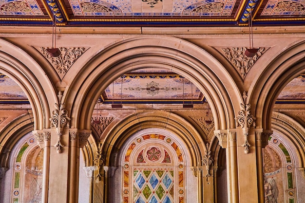 Stunning limestone arches and murals centered in frame at Central Park New York City