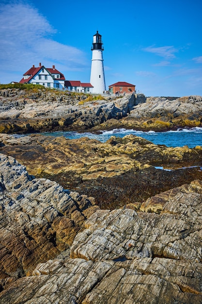 Stunning Maine white lighthouse on ocean along rocky coastline