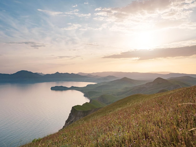 Stunning scenery in the sunset rays of the sea coast and mountains