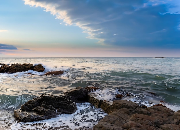 The stunning seascape with the colorful sky and last rays at the rocky coastline of the Black Sea