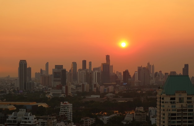 Stunning view of the bright sun setting over the city