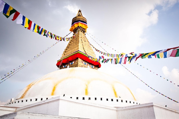 A stupa with a banner in the middle that says boudhanath.