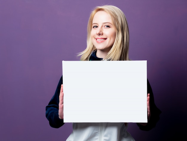 Style blonde woman in 80s clothes with white banner