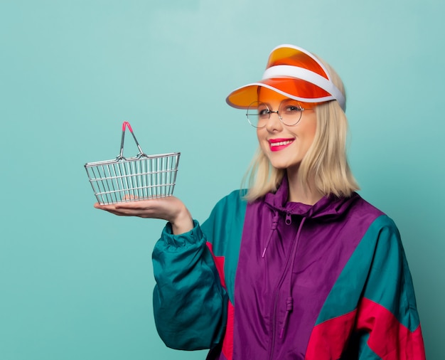 Style blonde woman in 90s sport suit with shopping basket