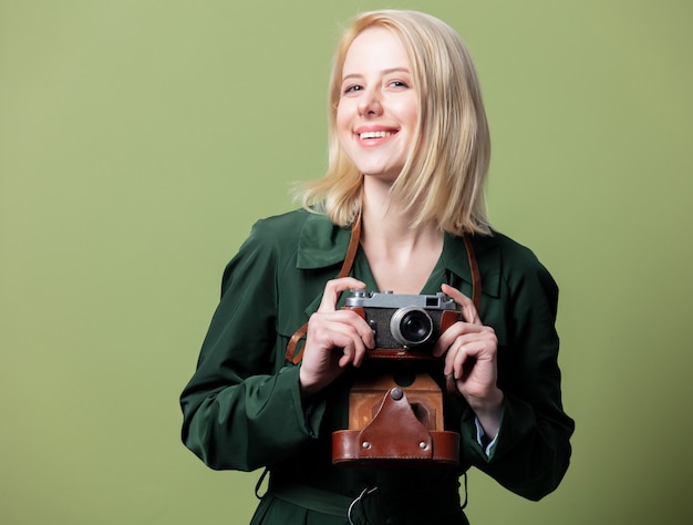 Style blonde woman in cloak with camera