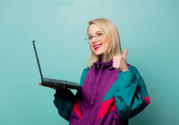 Photo style blonde woman in glasses with laptop computer