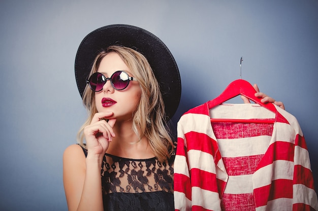 Style girl with jacket on hanger